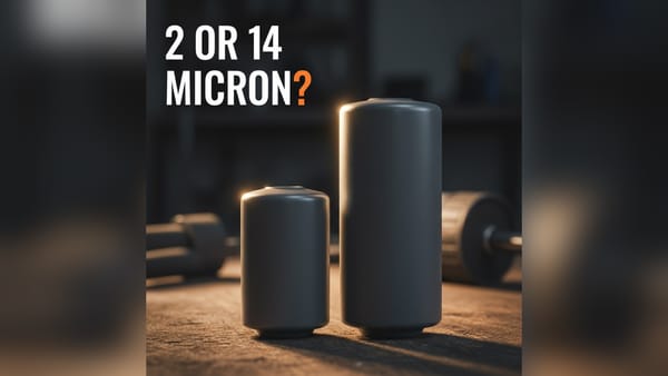 Two unmarked spin-on diesel fuel filters of different lengths on a workbench